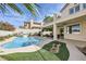 Expansive backyard with a sparkling pool, covered patio, and beautifully landscaped gardens at 150 Wentworth Dr, Henderson, NV 89074