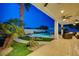Backyard features a paved patio with comfortable outdoor seating, a pool, and lush landscaping at 150 Wentworth Dr, Henderson, NV 89074