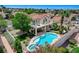 Aerial view of a home with a pool, spa, balcony, covered patio, and lush landscaping at 150 Wentworth Dr, Henderson, NV 89074