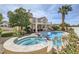 Beautiful backyard with a sparkling pool, spa, and lush tropical landscaping at 150 Wentworth Dr, Henderson, NV 89074
