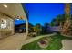 Well-manicured backyard with lush landscaping, tiled patio, and outdoor dining area at 150 Wentworth Dr, Henderson, NV 89074