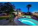 Backyard view of a home with a pool, spa, covered patio, and well-maintained landscaping at 150 Wentworth Dr, Henderson, NV 89074
