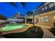 Backyard view with a pool, covered patio, and beautifully landscaped surroundings at 150 Wentworth Dr, Henderson, NV 89074