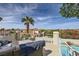 Serene balcony featuring cozy seating and picturesque views of the surrounding landscape and sparkling pool below at 150 Wentworth Dr, Henderson, NV 89074