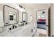 Modern bathroom features dual sinks, sleek fixtures, and a shower with striking black and white tile at 150 Wentworth Dr, Henderson, NV 89074