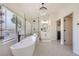 Stunning bathroom boasts a standalone tub, elegant chandelier, and large glass enclosed shower at 150 Wentworth Dr, Henderson, NV 89074