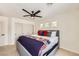 Comfortable bedroom featuring a ceiling fan, gray bed frame, and sliding door closet at 150 Wentworth Dr, Henderson, NV 89074