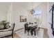 Dining room with modern black table, bench seating, decorative light fixture, and plantation shutters at 150 Wentworth Dr, Henderson, NV 89074