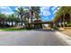 A grand entrance to a community featuring palm trees, lush landscaping, and a stone sign at 150 Wentworth Dr, Henderson, NV 89074