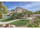 Stunning exterior view of the home with a well-manicured lawn, mature trees, and a sparkling pool at 150 Wentworth Dr, Henderson, NV 89074