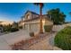 Beautiful two-story home with a two-car garage, desert landscaping, and a well-manicured lawn at 150 Wentworth Dr, Henderson, NV 89074