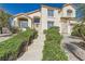 Two story house with desert landscaping, a tiled roof, and an arched entryway at 150 Wentworth Dr, Henderson, NV 89074