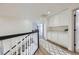 Bright hallway with storage cabinets, leading to bedrooms with a black and white staircase at 150 Wentworth Dr, Henderson, NV 89074