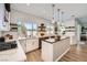 Bright kitchen features a center island, stone countertops, stylish tile backsplash, and stainless steel appliances at 150 Wentworth Dr, Henderson, NV 89074