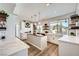 Bright kitchen with white cabinets, a center island, open shelving, and a large window overlooking the backyard at 150 Wentworth Dr, Henderson, NV 89074