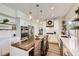 Modern kitchen featuring white cabinets, a wood-topped island, stainless steel appliances, and stylish pendant lighting at 150 Wentworth Dr, Henderson, NV 89074