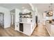 Charming kitchen featuring white cabinets, granite countertops, stainless steel appliances, and open shelving at 150 Wentworth Dr, Henderson, NV 89074