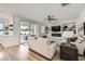 The living room has modern decor, a ceiling fan, access to the backyard, and a fireplace with a TV above at 150 Wentworth Dr, Henderson, NV 89074