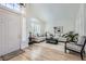 Bright living room featuring hardwood floors, plantation shutters, and high ceilings at 150 Wentworth Dr, Henderson, NV 89074