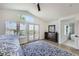 Bright main bedroom features a ceiling fan, French doors, and beautiful blue patterned rug at 150 Wentworth Dr, Henderson, NV 89074