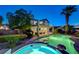 Inviting backyard oasis featuring a sparkling pool, lush landscaping, and a covered patio perfect for outdoor entertaining at 150 Wentworth Dr, Henderson, NV 89074