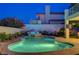 Stunning backyard pool and spa area illuminated at dusk, surrounded by mature landscaping at 150 Wentworth Dr, Henderson, NV 89074