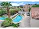 Backyard oasis featuring a pool and hot tub, with lush landscaping and a view of the golf course at 150 Wentworth Dr, Henderson, NV 89074