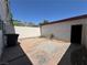 Enclosed backyard with concrete patio and access to storage, offering privacy and potential for outdoor enjoyment at 173 Greenbriar Townhouse Way, Las Vegas, NV 89121