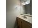 Well-lit bathroom features a vanity with drawers, sink, and mirror at 173 Greenbriar Townhouse Way, Las Vegas, NV 89121