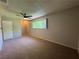 Spacious bedroom featuring neutral paint, a ceiling fan, and a window at 173 Greenbriar Townhouse Way, Las Vegas, NV 89121