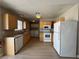 Functional kitchen with ample cabinet space, laminate floors, and essential appliances at 173 Greenbriar Townhouse Way, Las Vegas, NV 89121