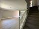Bright living room with hardwood floors and staircase to the second level at 173 Greenbriar Townhouse Way, Las Vegas, NV 89121