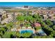 Aerial shot showcasing the community's pool, landscaping, and residential layout against a distant cityscape at 1794 Morro Vista Dr, Las Vegas, NV 89135