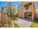Exterior of two-story home with a small balcony, manicured lawn and garden at 1794 Morro Vista Dr, Las Vegas, NV 89135