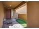 Inviting covered front porch with stone pavers, artificial turf, and a secure gated entrance at 1794 Morro Vista Dr, Las Vegas, NV 89135