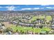 Aerial view of the community featuring lush landscaping, green golf courses, and mountain views at 1848 Indian Bend Dr, Henderson, NV 89074