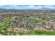 Vast aerial perspective highlights a residential area bordering a well-maintained golf course, promoting a serene suburban setting at 1848 Indian Bend Dr, Henderson, NV 89074