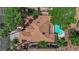 Aerial view showcases a home with a private pool, tile roof, and lush landscaping, in a desirable community at 1848 Indian Bend Dr, Henderson, NV 89074