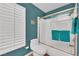 Bathroom featuring teal walls, a shower with glass doors and an updated toilet at 1848 Indian Bend Dr, Henderson, NV 89074