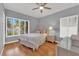 Bright bedroom with hardwood floors, a ceiling fan and a large window with plantation shutters at 1848 Indian Bend Dr, Henderson, NV 89074
