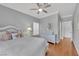 Bedroom features hardwood floors, a ceiling fan, and a woven style bed frame with a white comforter at 1848 Indian Bend Dr, Henderson, NV 89074