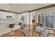 Bright breakfast nook features a glass table, bar seating, and sliding doors to the outside at 1848 Indian Bend Dr, Henderson, NV 89074