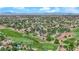 A panoramic aerial view captures the residential community adjacent to lush golf courses, blending luxury living with recreational amenities at 1848 Indian Bend Dr, Henderson, NV 89074
