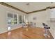 Cozy dining area with hardwood floors, a stylish table set, and large windows offering a view of the landscaped backyard at 1848 Indian Bend Dr, Henderson, NV 89074