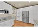 Modern kitchen featuring stainless steel appliances, granite counters, and white cabinetry at 1848 Indian Bend Dr, Henderson, NV 89074