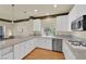 Beautiful kitchen with granite counters, stainless appliances, and custom white cabinetry at 1848 Indian Bend Dr, Henderson, NV 89074