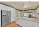 Beautiful kitchen with granite counters, stainless appliances, and custom white cabinetry at 1848 Indian Bend Dr, Henderson, NV 89074