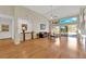 Bright and airy living room with hardwood floors, a vaulted ceiling, a ceiling fan, and large windows overlooking the pool at 1848 Indian Bend Dr, Henderson, NV 89074