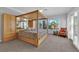 Spacious main bedroom featuring a four-poster bed, natural light and built-in wardrobes at 1848 Indian Bend Dr, Henderson, NV 89074