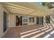 Covered outdoor patio featuring tile flooring, sliding glass doors, and string lights for evening ambiance at 1848 Indian Bend Dr, Henderson, NV 89074